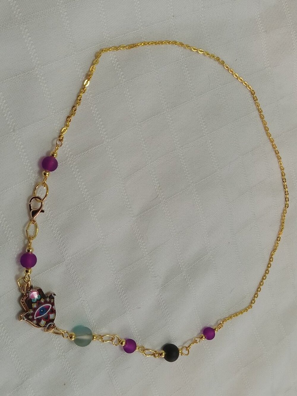 A pretty, minimalist, asymmetrical, reversible handmade necklace